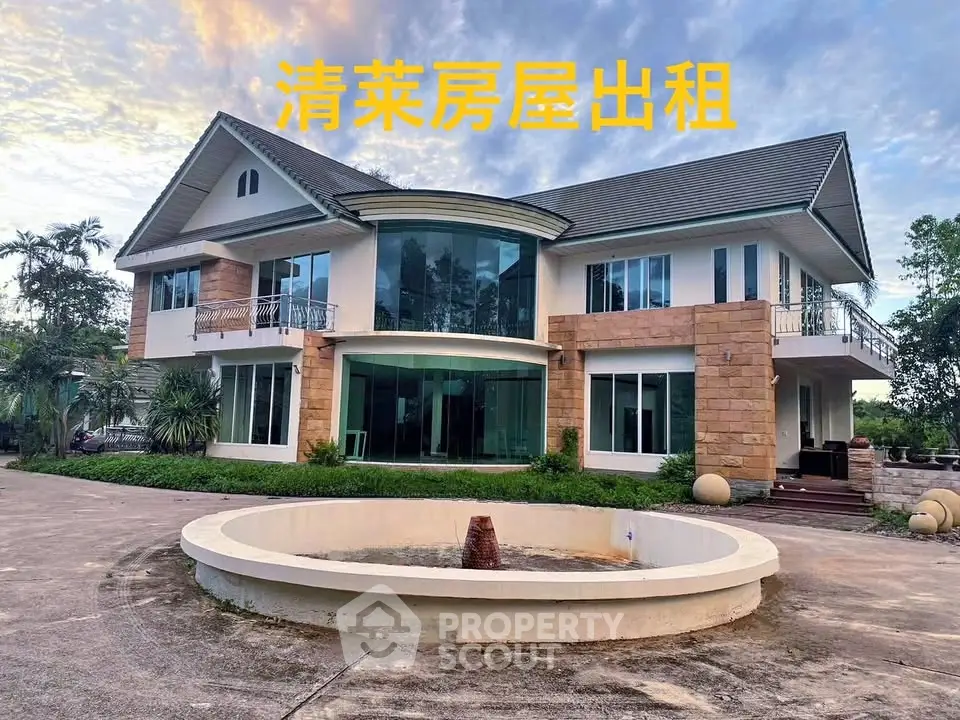 Stunning two-story house with large windows and spacious driveway for rent.