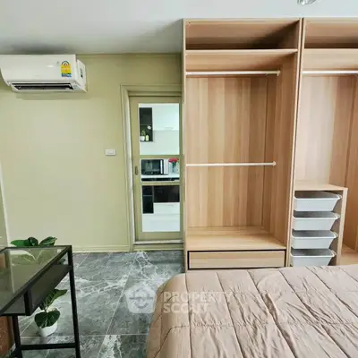 Modern bedroom with open wardrobe and air conditioning in a stylish apartment.