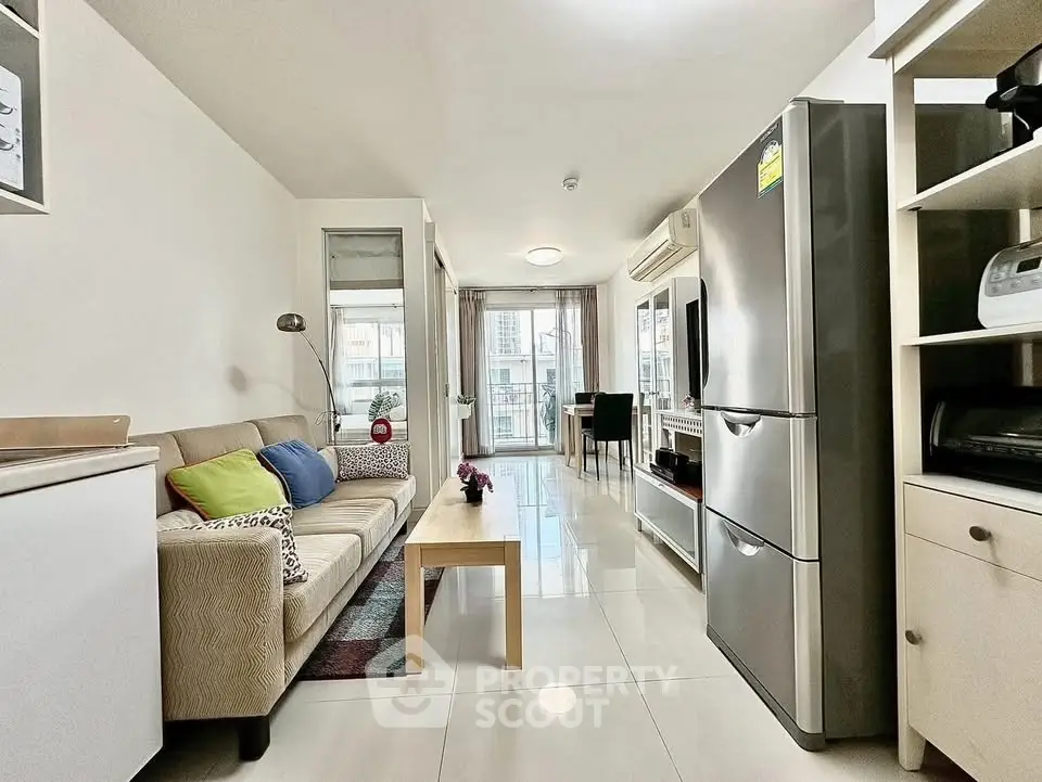 Modern living room with sleek design, featuring a cozy sofa, stylish decor, and a spacious layout with natural light.