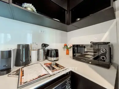Modern kitchen corner with sleek appliances and open cookbook