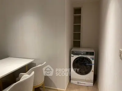 Cozy laundry nook with Electrolux washing machine and seating area