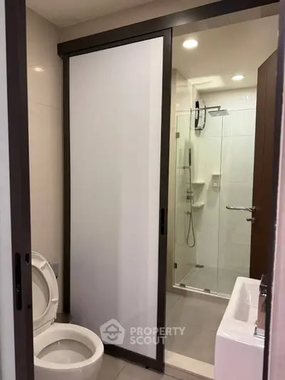 Modern bathroom with sliding door and glass shower enclosure