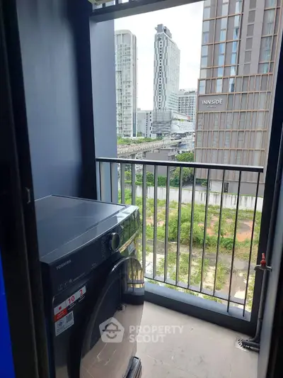 Modern balcony with washing machine and city view in urban apartment