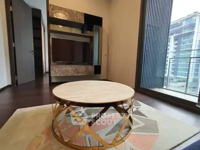 Modern living room with stylish coffee table and balcony view in luxury apartment.