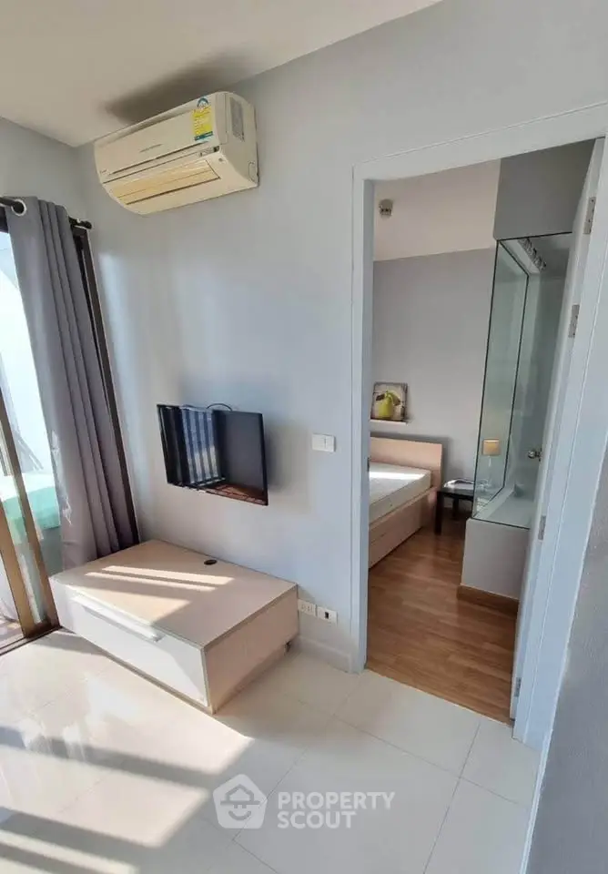 Modern apartment interior with air conditioning and natural light, featuring a cozy bedroom and sleek design.