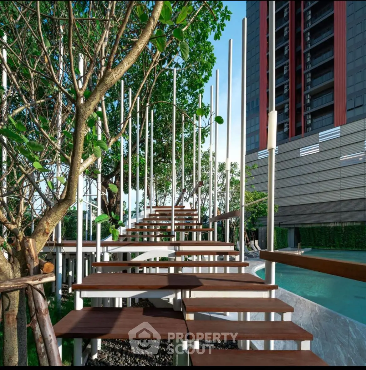 Modern outdoor staircase with sleek design near a pool in urban residential complex.