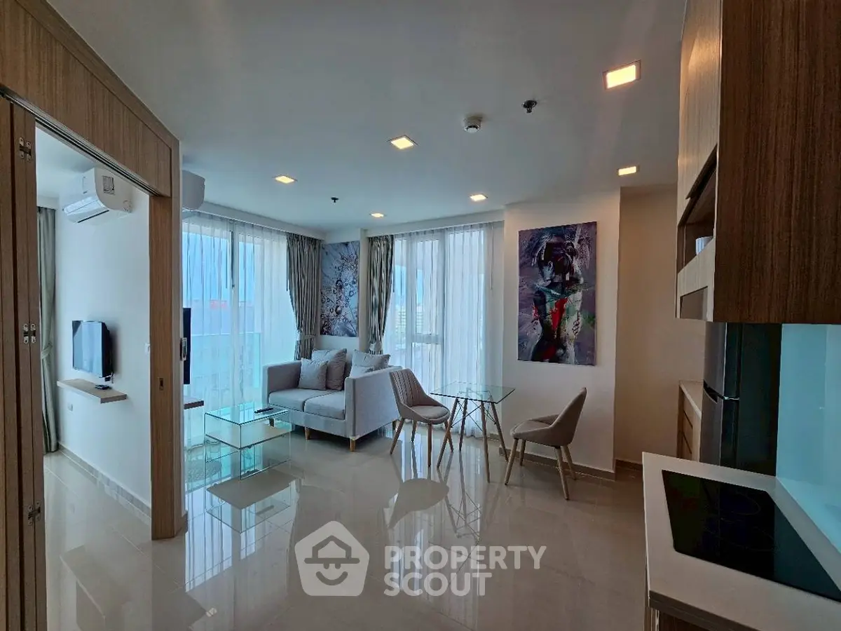 Modern living room with sleek furniture and large windows in a stylish apartment.