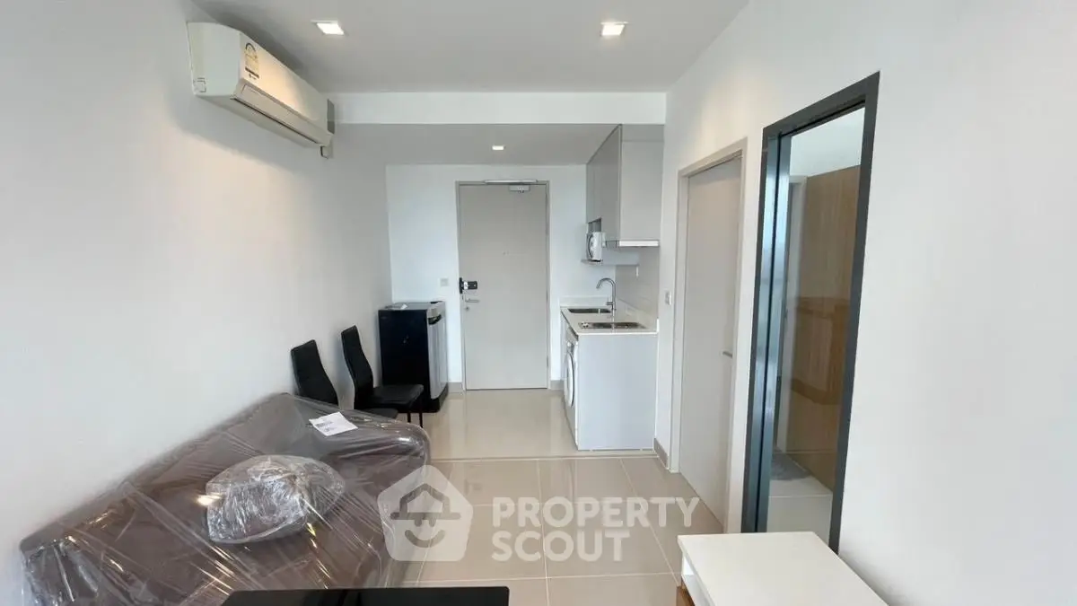 Modern apartment living room with compact kitchen and sleek design