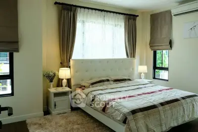 Cozy bedroom with elegant decor and natural light, featuring a plush bed and stylish curtains.