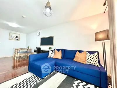 Spacious living room with modern blue sofa and stylish decor