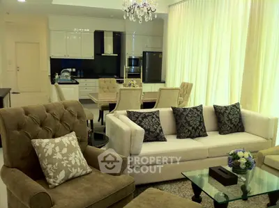 Luxurious open-plan living room with elegant furniture and modern kitchen