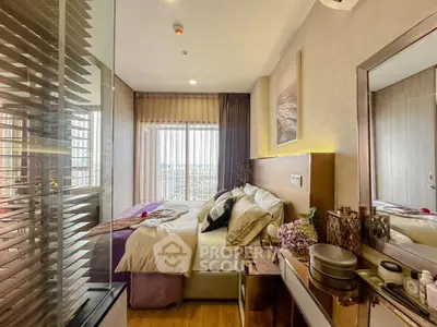 Luxurious bedroom with modern decor and stunning city view from large window.