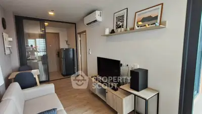 Modern living room with stylish decor and natural light, featuring a cozy sofa and entertainment center.