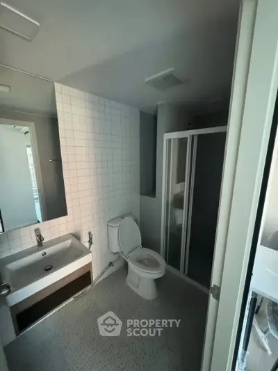 Modern bathroom with sleek fixtures and glass shower enclosure