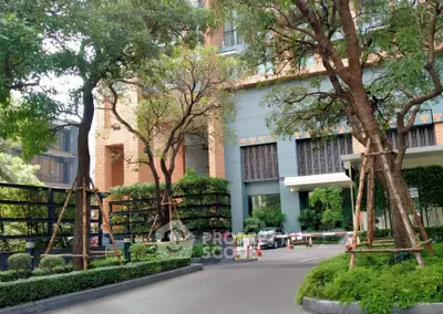 Elegant building entrance with lush greenery and modern architecture