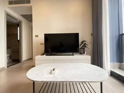 Modern living room with sleek TV setup and elegant marble coffee table.