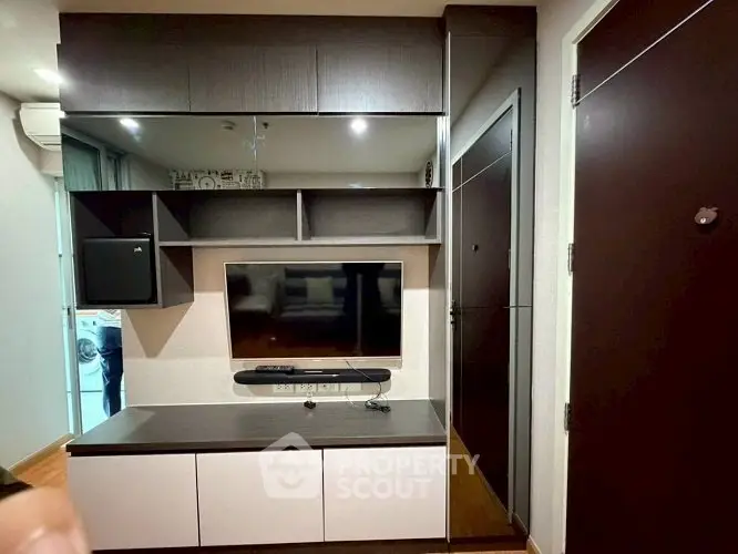 Modern living room with sleek TV unit and stylish storage solutions.