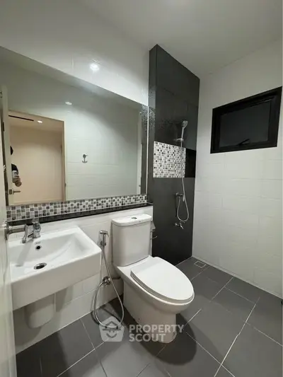 Modern bathroom with sleek fixtures and stylish tile design, perfect for contemporary living.