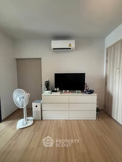 Modern living room with air conditioning and wooden flooring