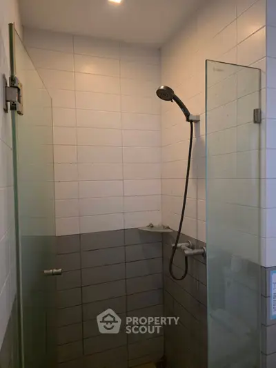 Modern bathroom with glass shower enclosure and sleek tile design