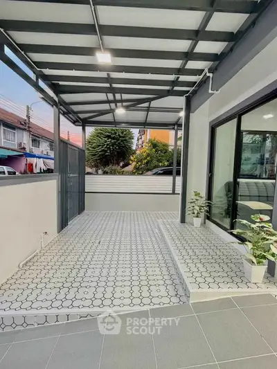 Modern outdoor patio with stylish tile flooring and sleek metal roof, perfect for relaxation and gatherings.