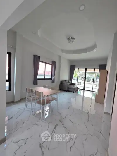 Spacious modern living room with marble flooring and large windows