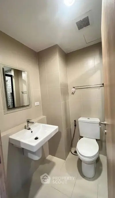 Modern bathroom with sleek fixtures and neutral tiles, ideal for contemporary living.