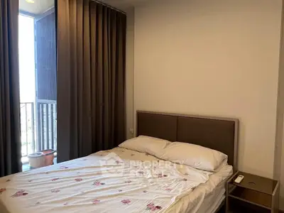 Cozy bedroom with natural light and modern decor, perfect for relaxation.