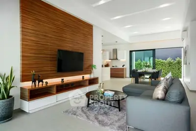 Modern open-plan living room with sleek furniture and wooden accent wall