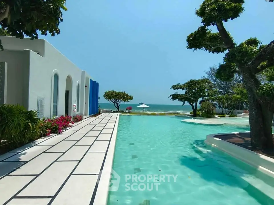 Luxurious beachfront property with stunning pool and ocean view.
