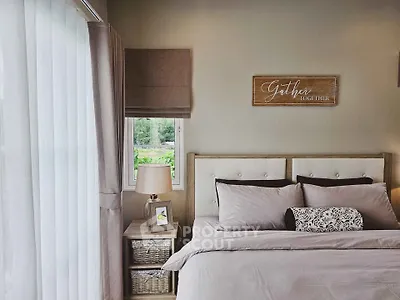 Cozy bedroom with elegant decor and natural light, perfect for relaxation.