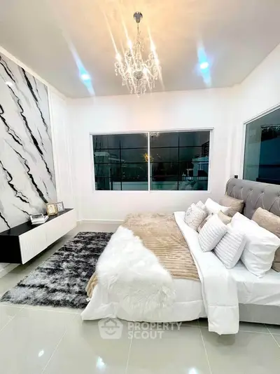 Luxurious bedroom with elegant chandelier and modern decor