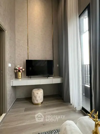 Modern living room with high ceilings, stylish decor, and large windows for natural light.