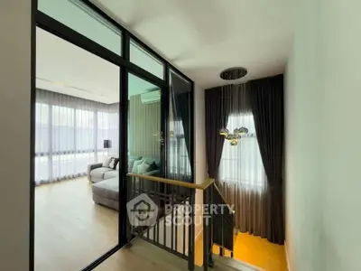 Modern interior with glass partition and elegant lighting in a stylish home.