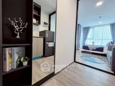 Modern apartment interior with cozy living room and compact kitchen, featuring stylish decor and natural light.
