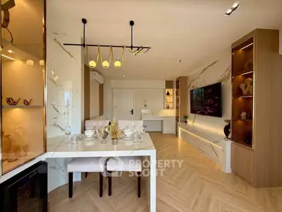 Luxurious modern living room with elegant decor and open layout, featuring stylish lighting and sleek furniture.