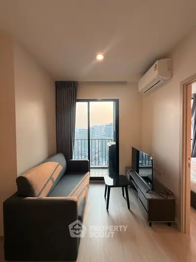 Modern living room with city view, featuring a sleek sofa and entertainment unit, perfect for urban living.