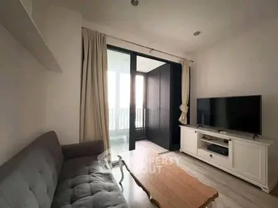 Cozy living room with modern decor and balcony access