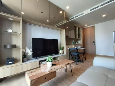 Modern living room with sleek furniture and large TV in stylish apartment