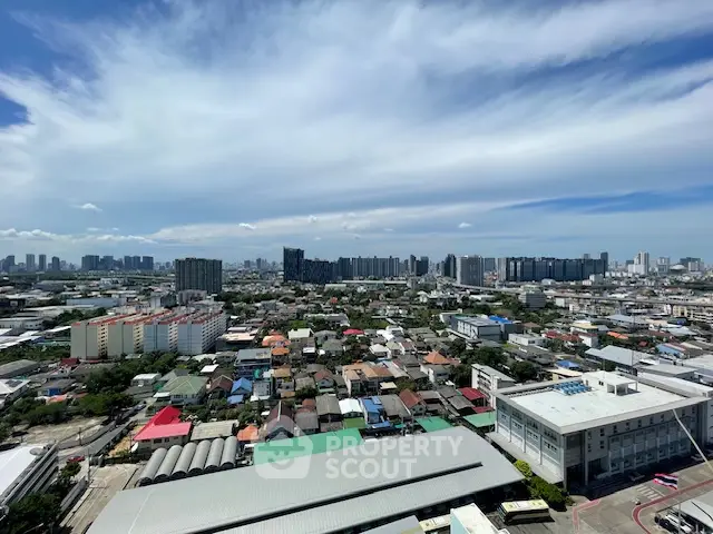 Stunning cityscape view showcasing urban skyline and residential areas under a vibrant blue sky.