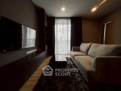 Modern living room with sleek furniture and large window view.