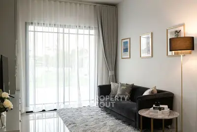 Modern living room with elegant decor and large window for natural light.
