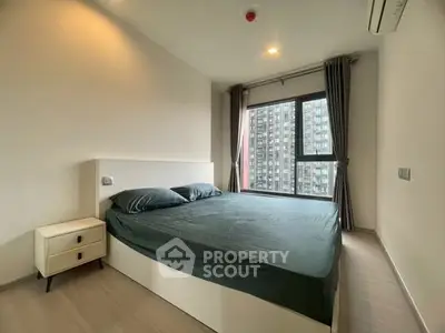 Modern bedroom with large window and city view in high-rise apartment