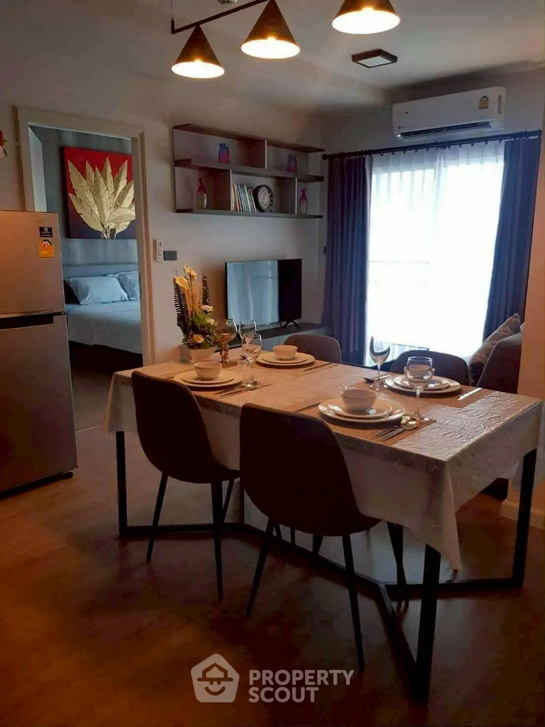 Modern dining area with elegant table setting and cozy living room ambiance.