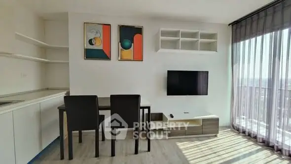 Modern living room with sleek furniture and large windows offering ample natural light.