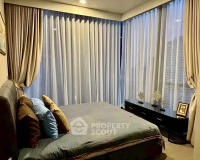 Luxurious bedroom with floor-to-ceiling windows and elegant decor in a modern high-rise apartment.