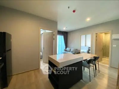 Modern open-plan living area with kitchen island and cozy seating, perfect for urban living.