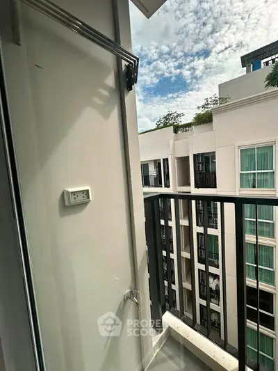 Modern apartment balcony with city view and sleek railing design