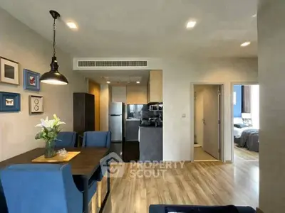 Modern open-plan living and dining area with stylish decor and natural light.