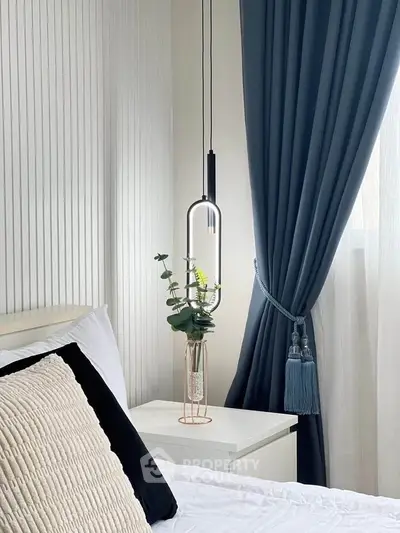 Elegant bedroom with modern pendant light and stylish decor